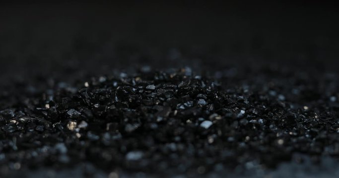 Sprinkle jewel onyx or carbon material on black background
