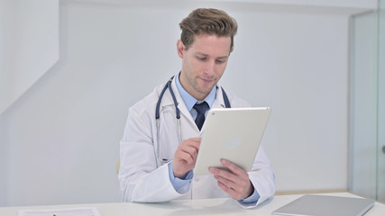 Young Male Doctor using Tablet in Modern Office