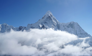 Ama Dablam 6814m clouds covered peak View near Dingboche settlement in Sagarmatha National Park, Nepal. Everest Base Camp (EBC) trekking route.