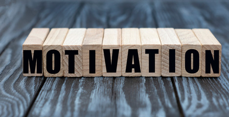 motivation word on cubes on a gray wooden background