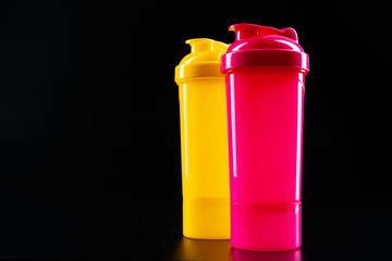 Sport bottle for drink on black background close up
