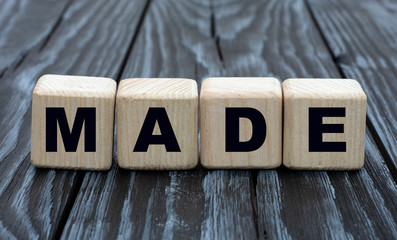 Made word on cubes on a gray wooden background