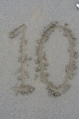 written number on sand