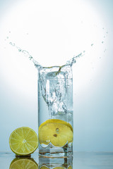 Fototapeta na wymiar water with lemon and lime in glass isolated on white