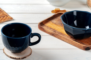 Classic blue empty ceramic tea cup on kitchen table close up