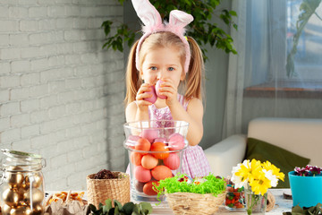 Happy little girl with bunny ears getting ready for Easter party