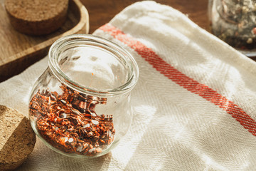 Striped linen napkin on wooden table with kitchen utensils close up