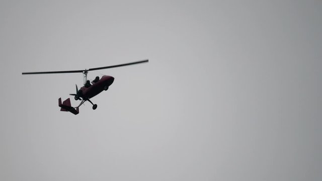 Gyroplane flying in the sky over the airfield. Aviation festival holiday at the aerodrome airport