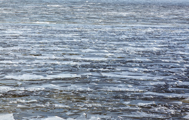 Small ice floes float on the surface of the sea. Background.