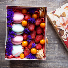 gift box with berries and macaroons