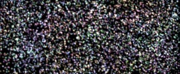 glittery bright shimmering background perfect as a rainbow backdrop.Element of design.iridescent sprocket, shiny confetti. Scattered little sparkling, glitter balls, circles.  New Year Christmas .