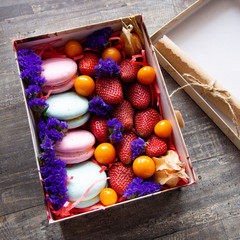 gift box with berries and macaroons
