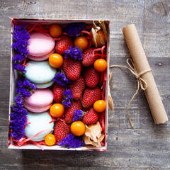 gift box with berries and macaroons