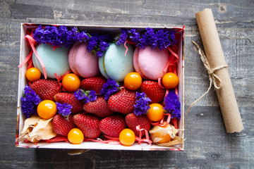 gift box with berries and macaroons