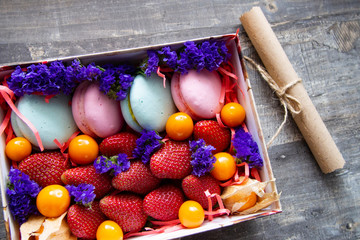 gift box with berries and macaroons