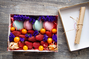 gift box with berries and macaroons