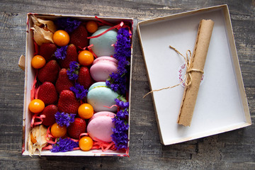 gift box with berries and macaroons