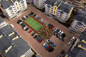 Playground and parking in the courtyard of a modern residential complex.