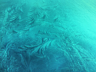 Frozen glass, ice flowers, winter background, abstract texture