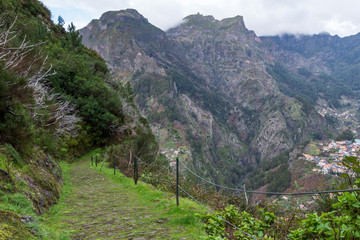 Stone paved levada walk down picture down from Eira do Serrado to the Valley of the Nuns (Curral...