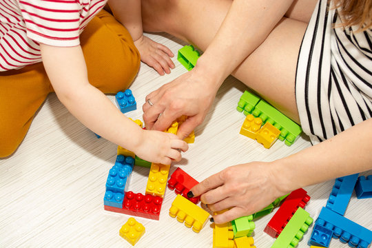 Child And Mother Play Together With Colorful Constructor Blocks 