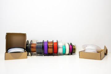 3D printing filament reels for 3d printers in boxes on white background