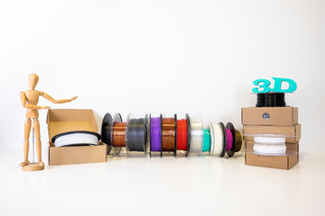 3D printing filament reels for 3d printers in boxes with wooden anthropomorphic doll with text 