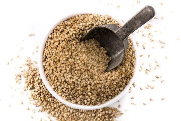 Sesame seeds in bowl isolated on white bowl top view