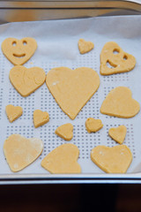 Cookies cut in dough on baking tray. Taking part in baking workshop. Baking classes for children, aspiring little chefs. Learning to cook. Combining and stirring prepared ingredients