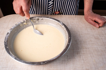 Dough for crepes or pancakes in glass bowl top view