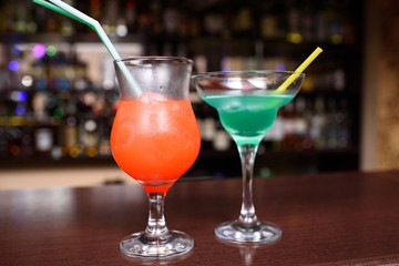 Bar counter cocktails blue lagoon and bay breeze. Alcoholic drinks. Harmful drinks.