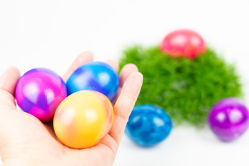Three colorful Easter eggs held in hand