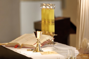 Chalice on the altar and Roman Missal in the background