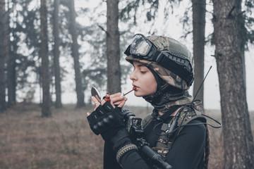 girl in camouflage with a weapon