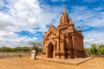 Buddhist pagoda temple. Bagan, Myanmar. Home of the largest and denset concentration of religion Buddhist temples, pagodas, stupas and ruins in the world. Blue sky with clouds.