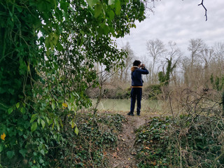 Boy films the swamp in the natural area of ​​Punte Alberete, in Ravenna, Italy