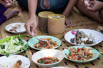 eating northern food menu with hand on rattan mat