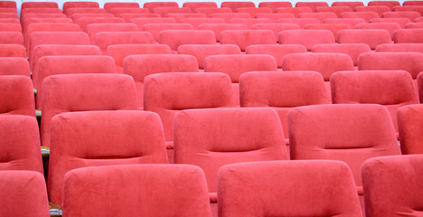Fototapeta premium Empty red soft chairs. Concept of quarantine, an empty auditorium in a cinema, theater, public events.