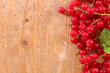 red currant on wood background- top view