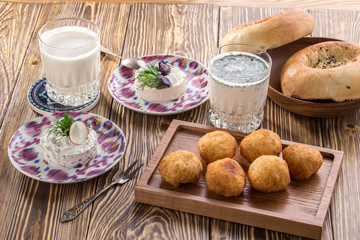 Traditional Uzbek Flat Bread With sour milk drink On wooden table