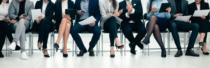 group of employees using their devices in the conference room.