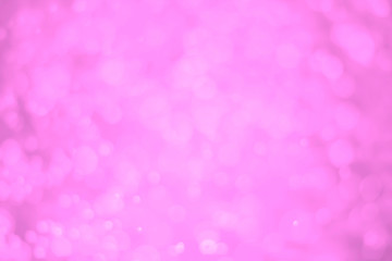 Pink glitter vintage lights background. White bokeh on pink background.