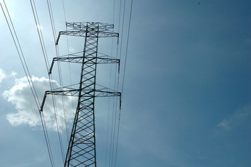 High voltage mast against the sky