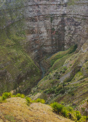 Santo Antao, Cape Verde. Mountain ridge with dry waterfall of canyon with steep cliff and winding riverbed with lush green vegetation