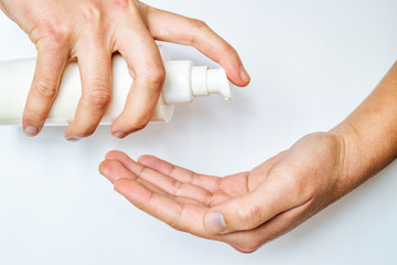 Woman opens hand for disinfection to viruses. Use cream to clean hands.