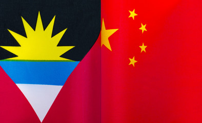 fragments of the national flags of Antigua and Barbuda and China close up