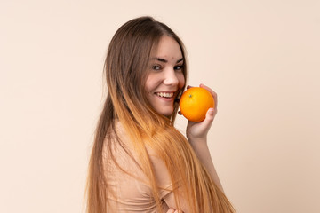 Young caucasian woman holding an orange