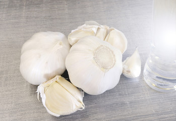 Garlic bulbs and garlic cloves with a glass of alcohol rakia