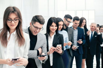 group of young people reading messages on their smartphones