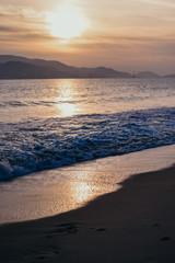 Sea wave on a beautiful pink sunset
